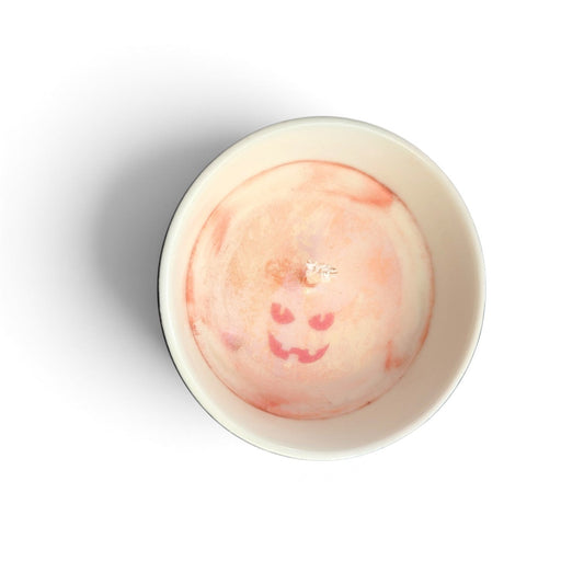 Fresh Start Candles Harvest Night soy wax candle with a carved pumpkin face design in a white ceramic container.