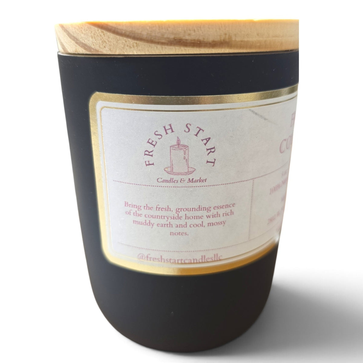 Fresh Start Candles Fresh Country 8oz soy wax candle in a matte black jar with a wooden lid and gold-trimmed label.